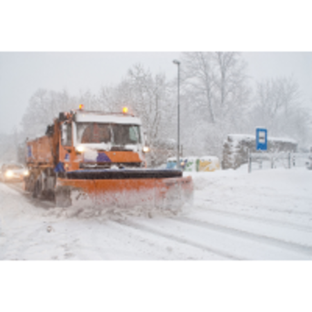 stock photo of a snowplow plowing a road