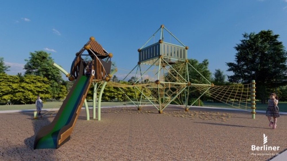 Image of playground equipment including slides, climbing equipment and shade.